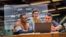 group of 3 people working on 1 laptop